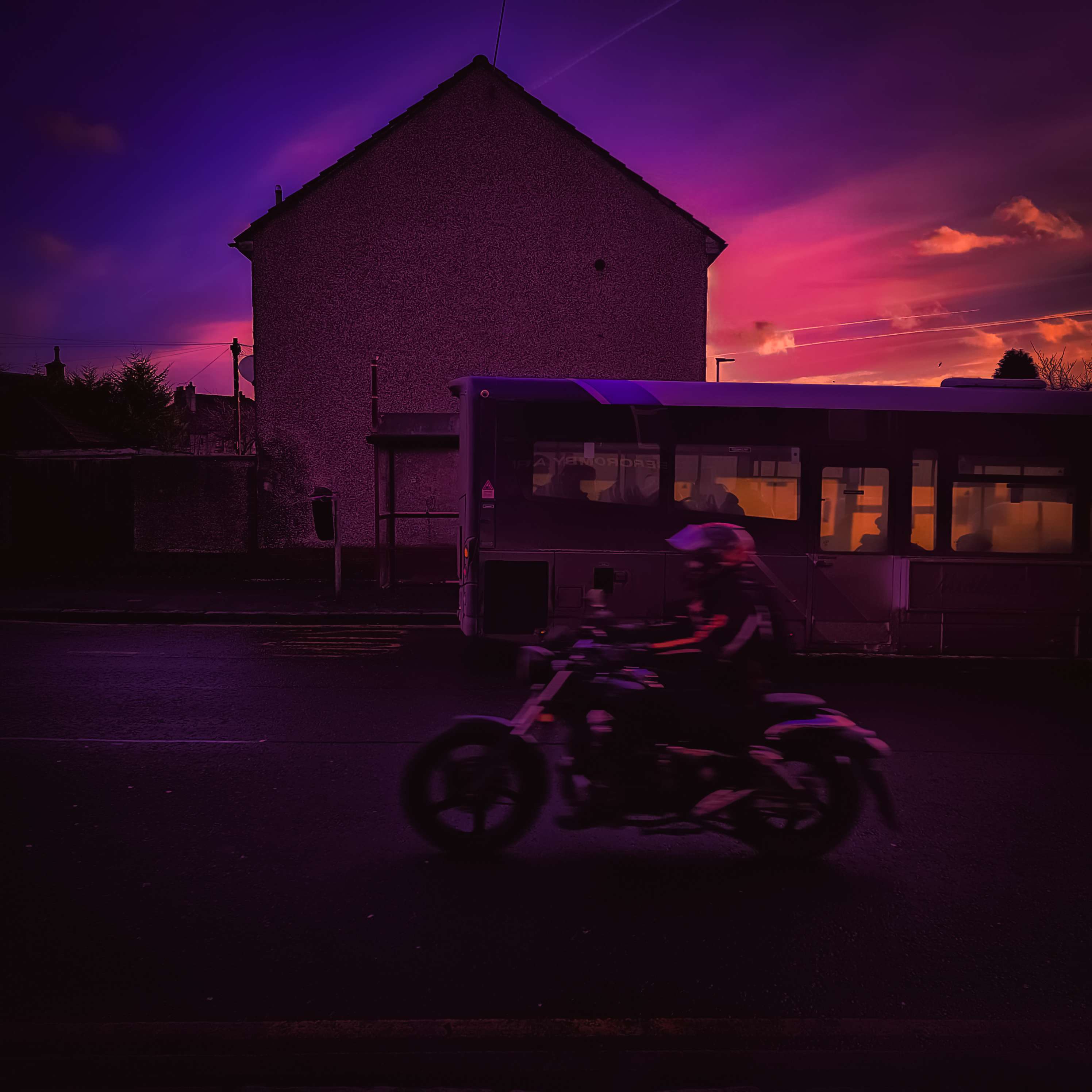 Motorbiker under a coloured sky